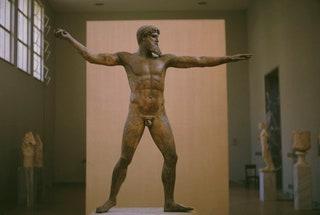 A bronze sculpture of the god Zeus or possibly Poseidon in the National Archaeological Museum in Athens Greece